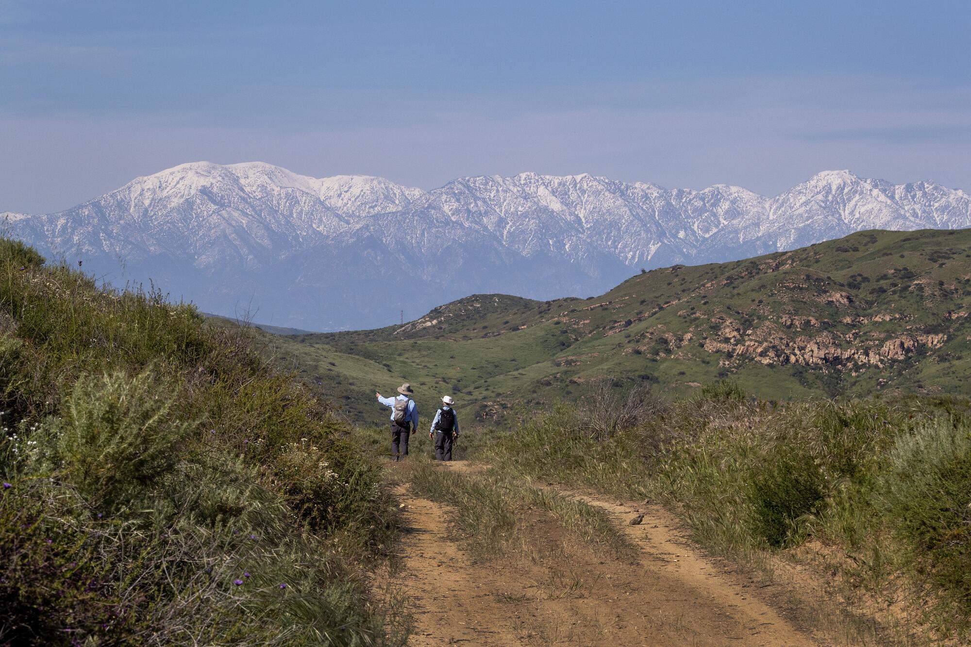 Hikers Tom McDonnell, of Irvine, left, and Roxanne Bradley, of Westminster, hike a scenic trail at Saddleback Wilderness.