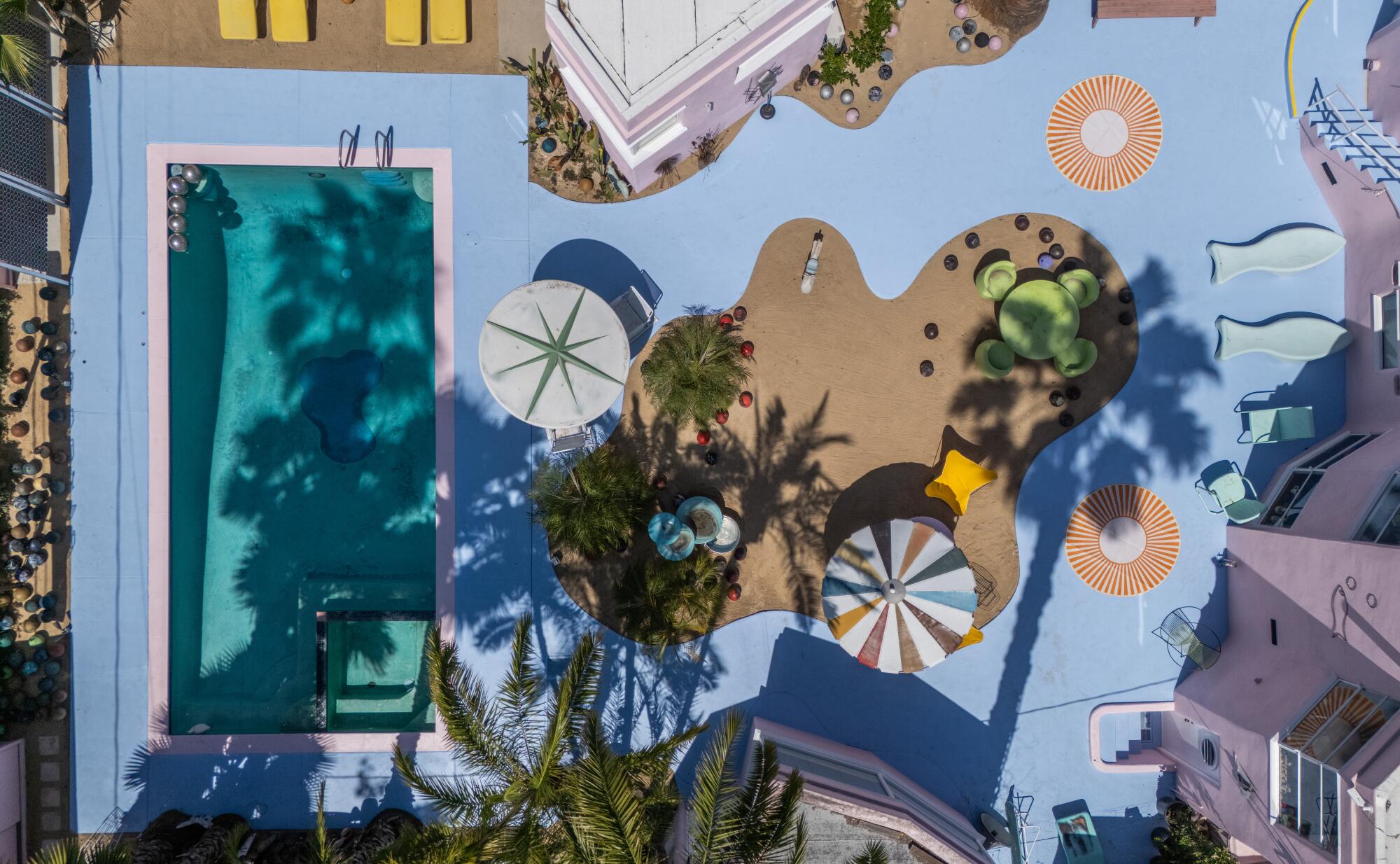 A pool and sand pit area in the backyard.