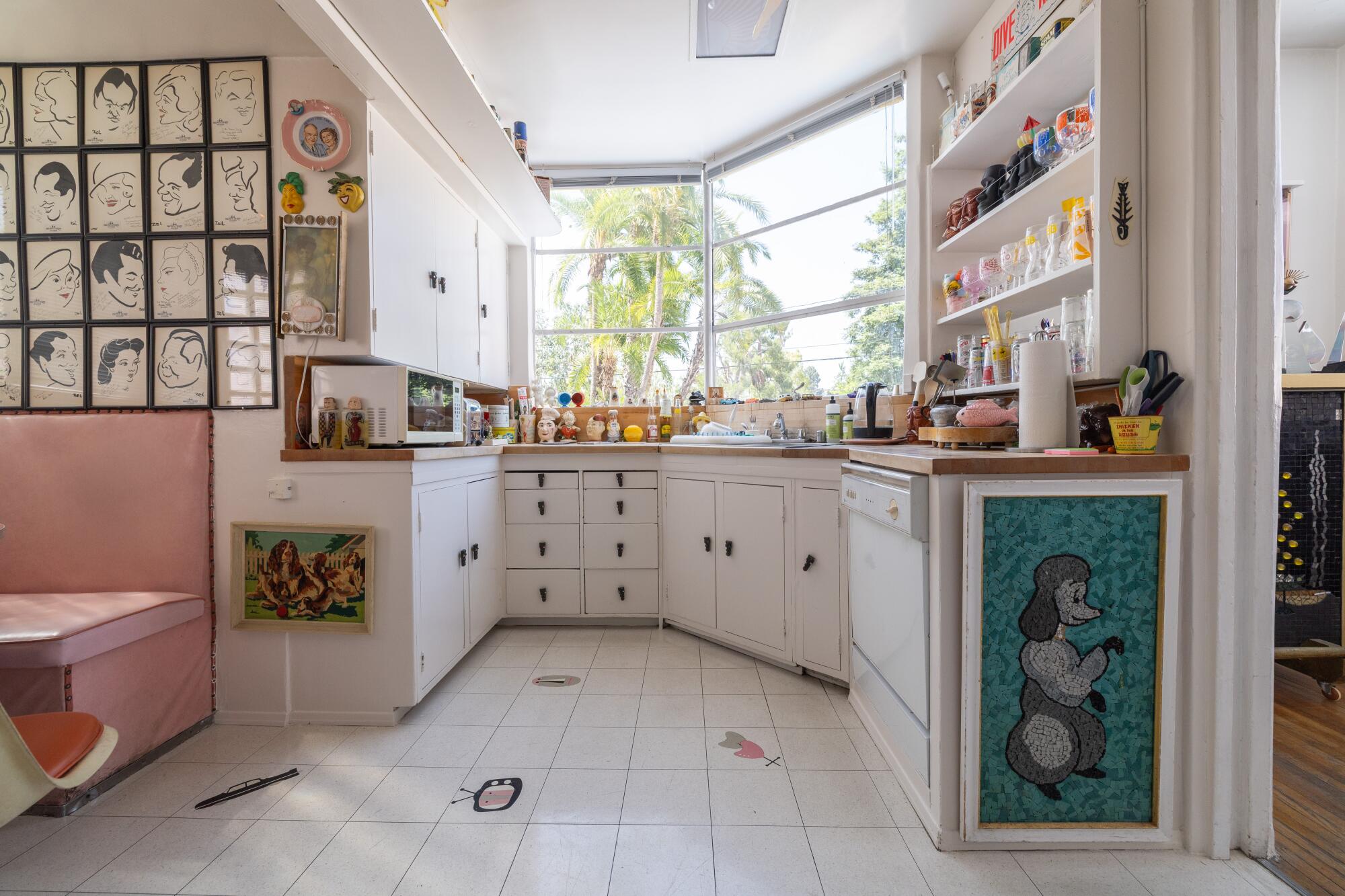 The kitchen is decorated with drawings, tchotchkes and collectibles.