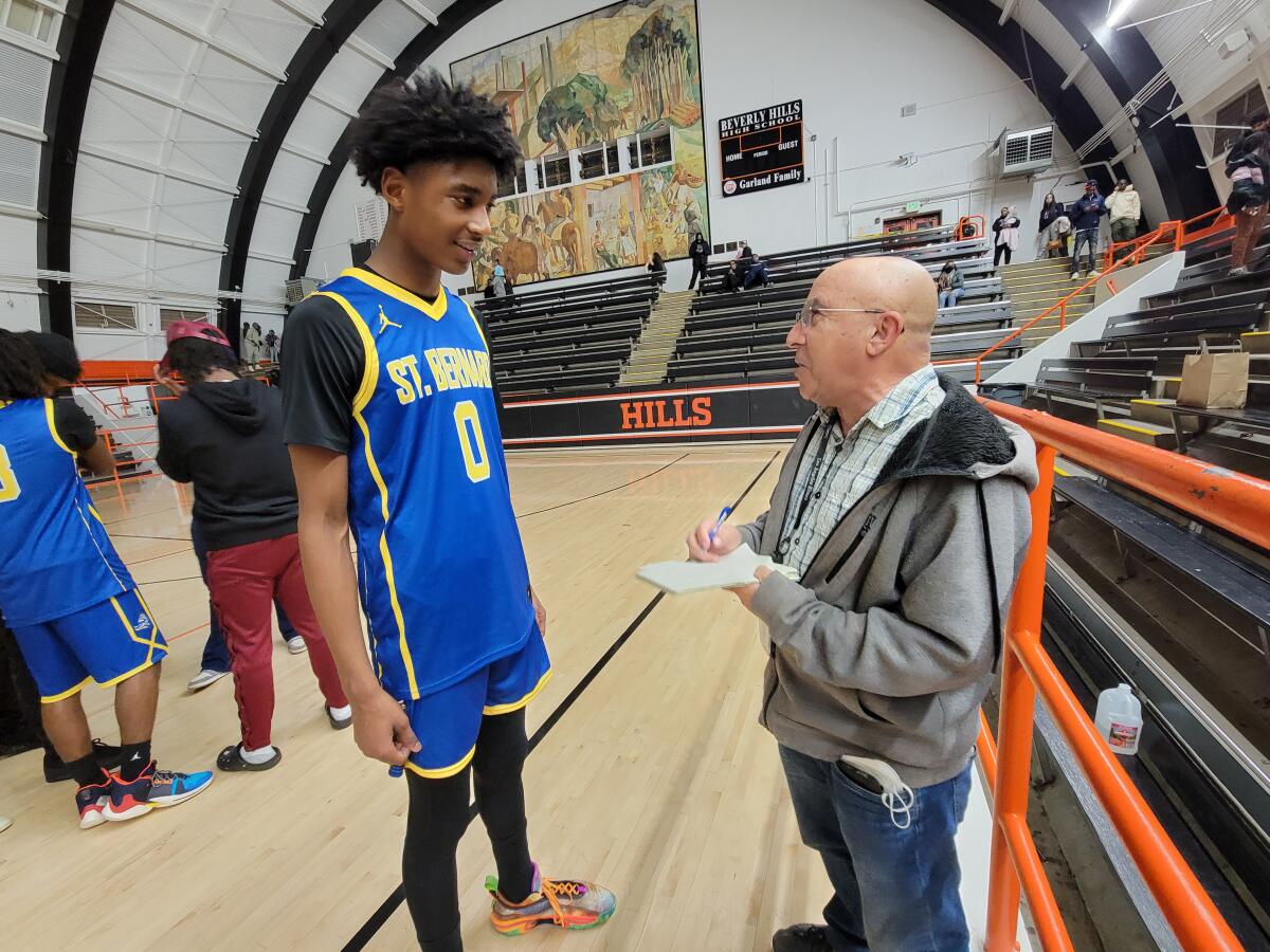 Eric Sondheimer interviews sophomore Tajh Ariza after a basketball game in 2022.
