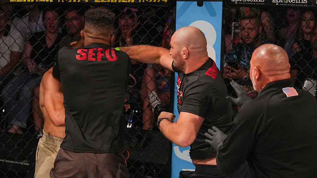 Sean Strickland throws a punch as a cornerman at Luis Hernandez