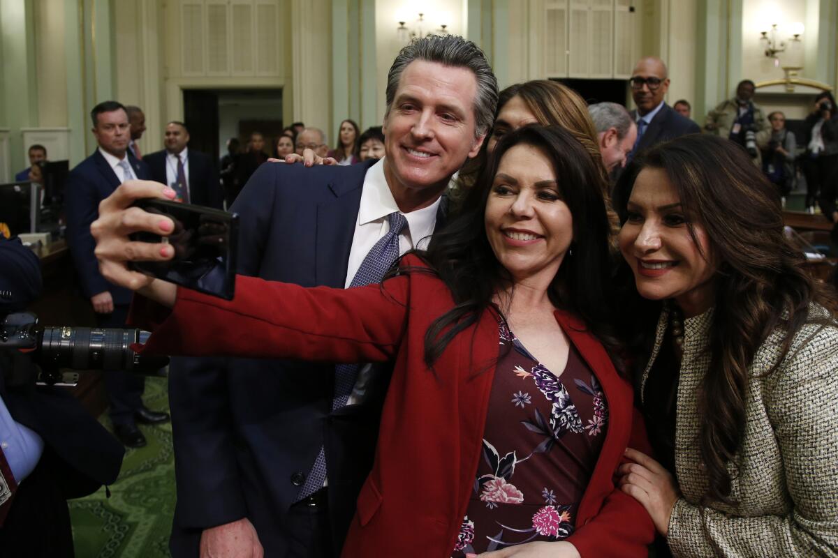 Gavin Newsom posing for a selfie with the Rubio Sisters