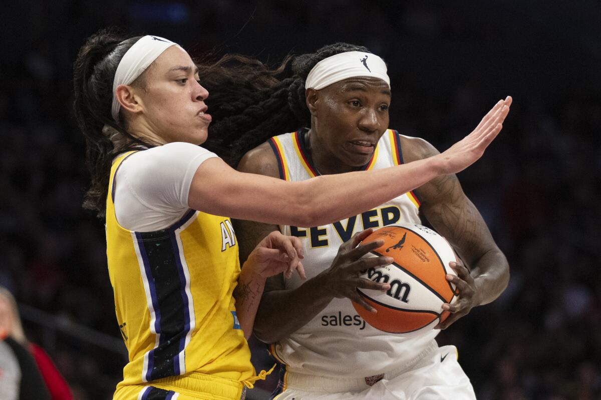 Indiana Fever forward Natasha Howard drives to the basket while being guarded by Sparks forward Dearica Hamby.