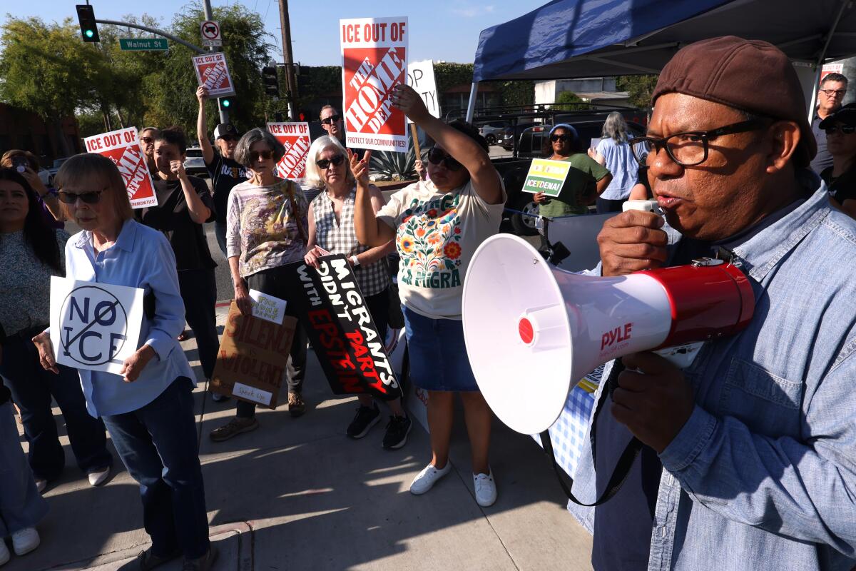 Pablo Alvarado, right, co-director of National Day Laborer Organizing Network, speaks to Anti-ICE protesters on Aug. 6.