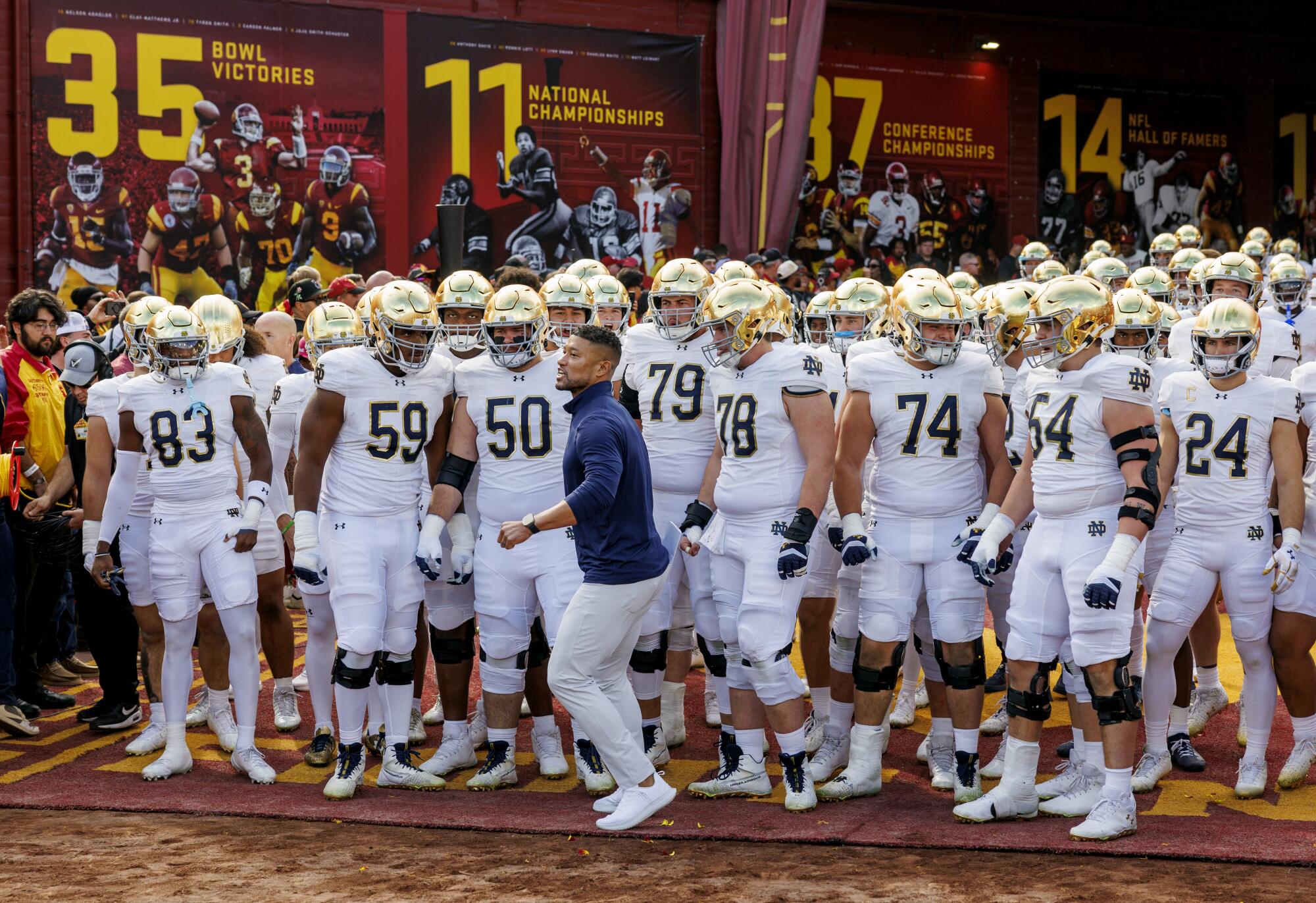 Notre Dame coach Marcus Freeman and his team line up to enter the field against USC at the Coliseum on Nov. 30.