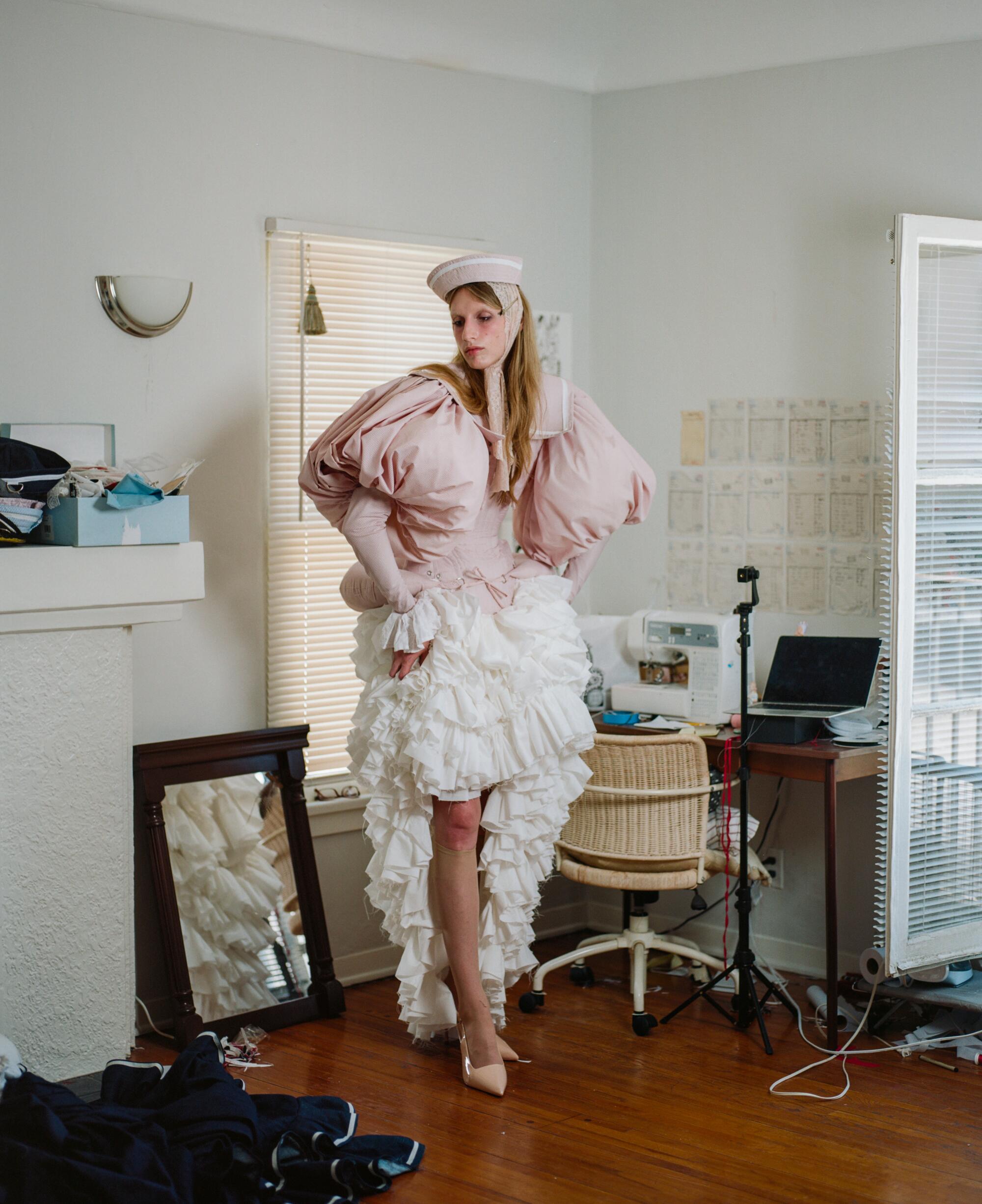 Erik Charlotte poses in her apartment.