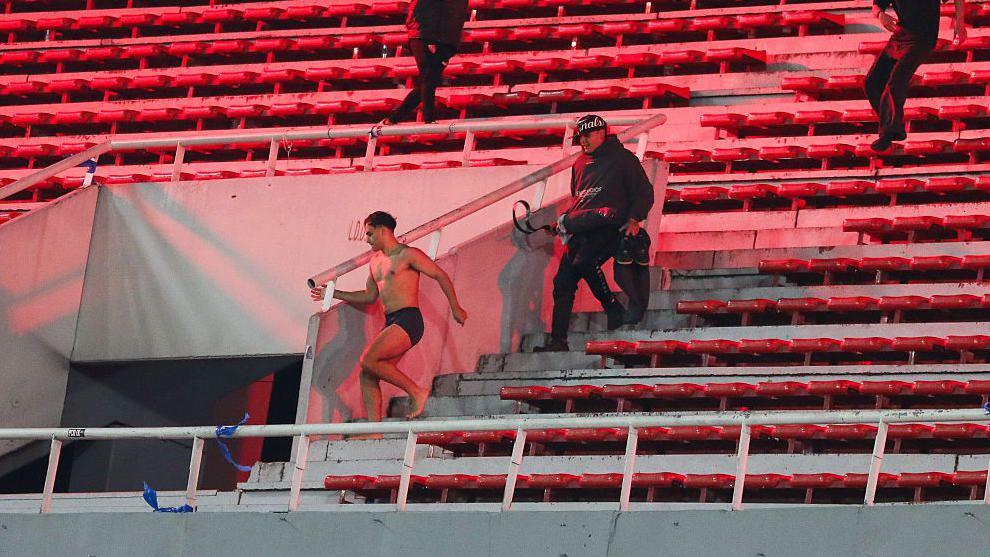 A supporter flees in the home section