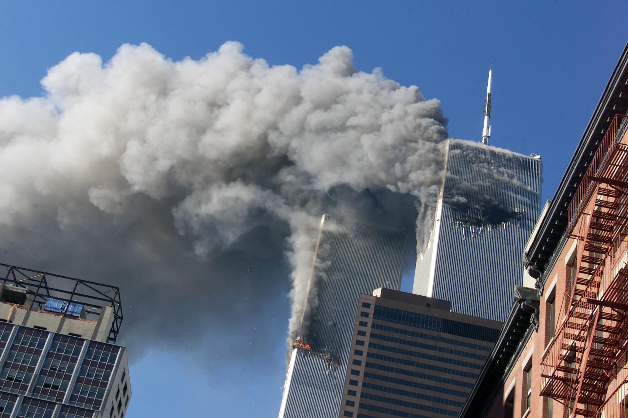 Smoke rises from the burning twin towers of the World Trade Center after hijacked planes crashed into the towers