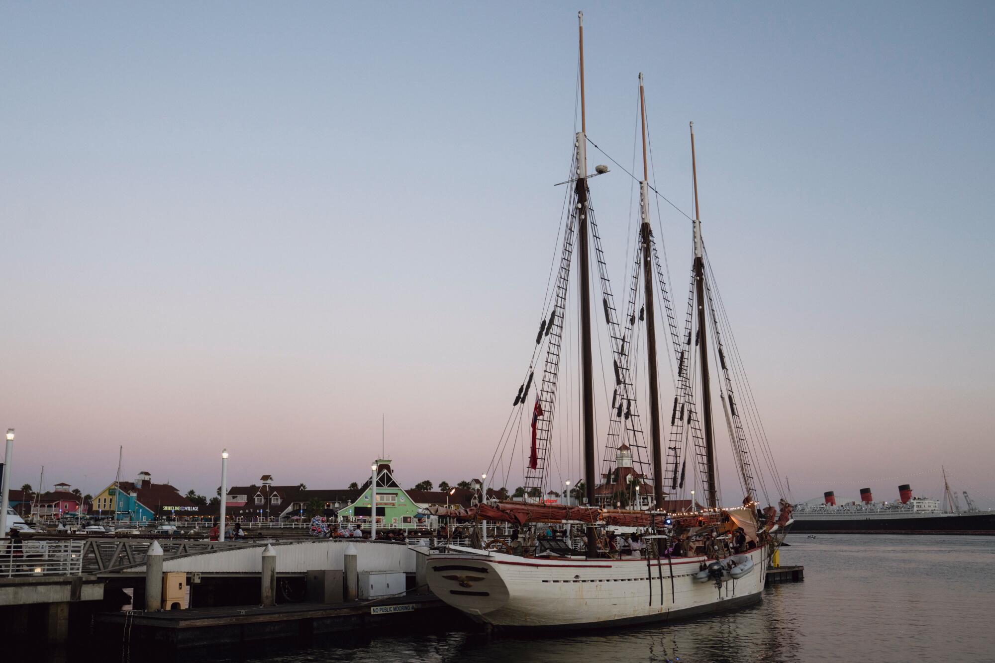 A three mast schooner at a dock.
