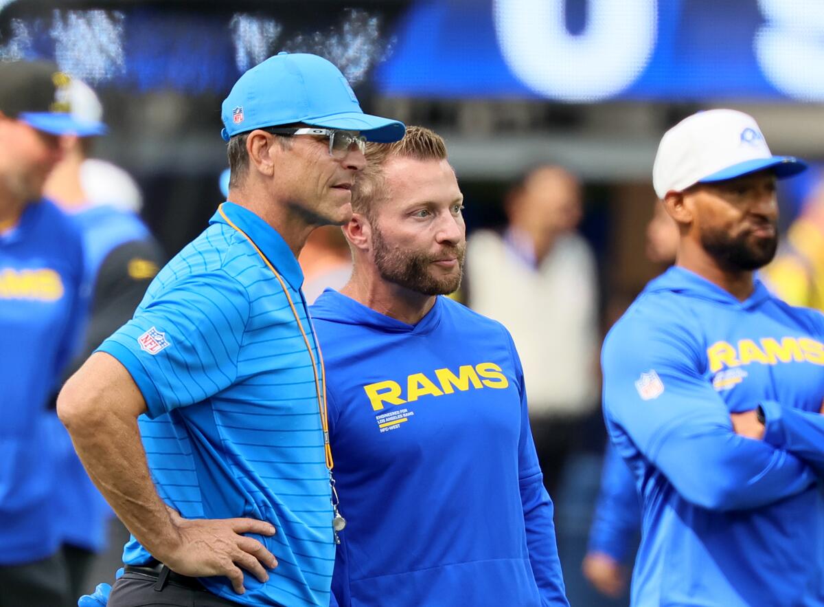 Chargers coach Jim Harbaugh, left, talks to Rams coach Sean McVay before the game.