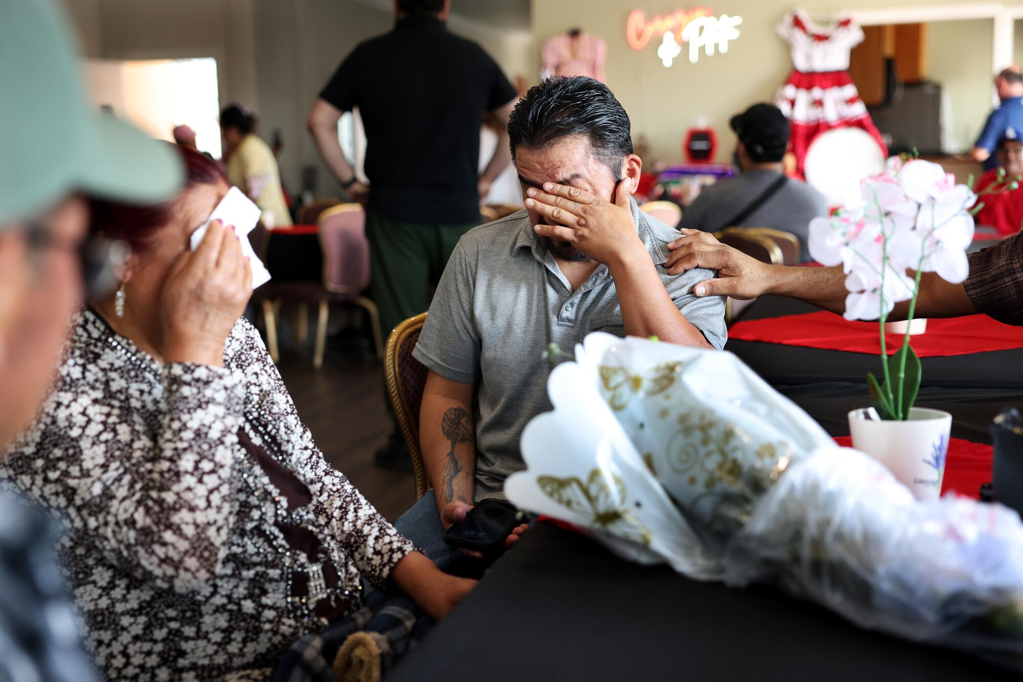 José Antonio Rodríguez and his mother, Juana Contreras Sánchez, wipe tears from their eyes after being reunited.