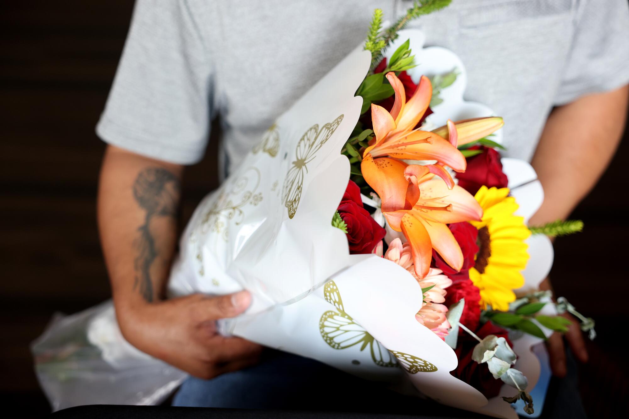 a man holds a bouquet of flowers