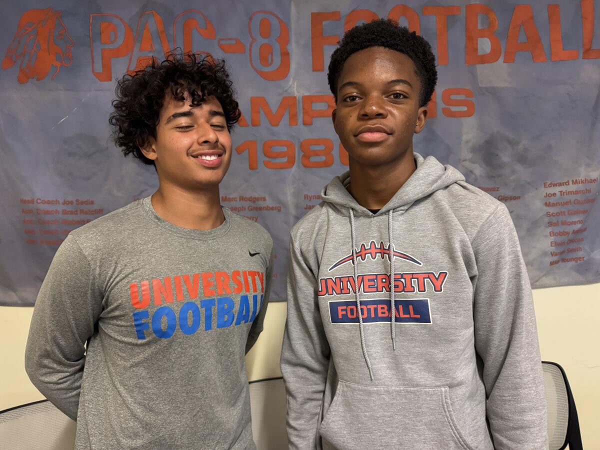 University quarterback Jeremy Pacheco (left) and defensive back Tareq Abdul.