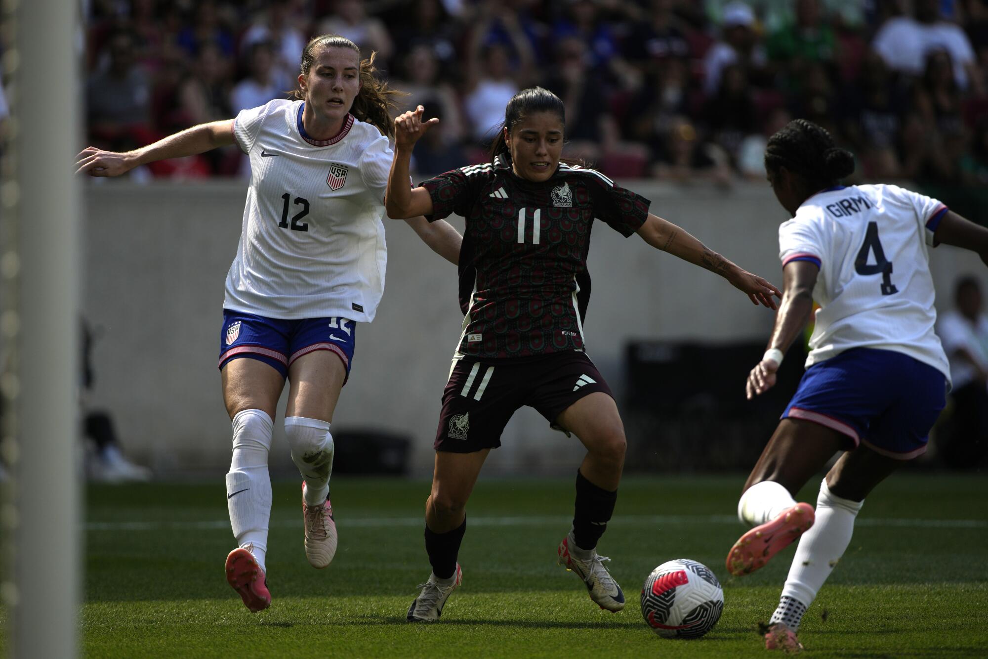 Mexico forward Lizbeth Ovalle controls the ball in from of U.S. defender Tierna Davidson during a friendly match.