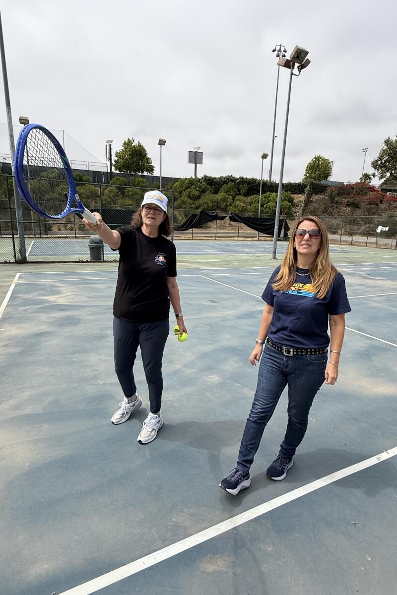 Pam Shriver and Ilise Freidman walk around the tennis courts at the Palisades Tennis Center on Aug. 16.