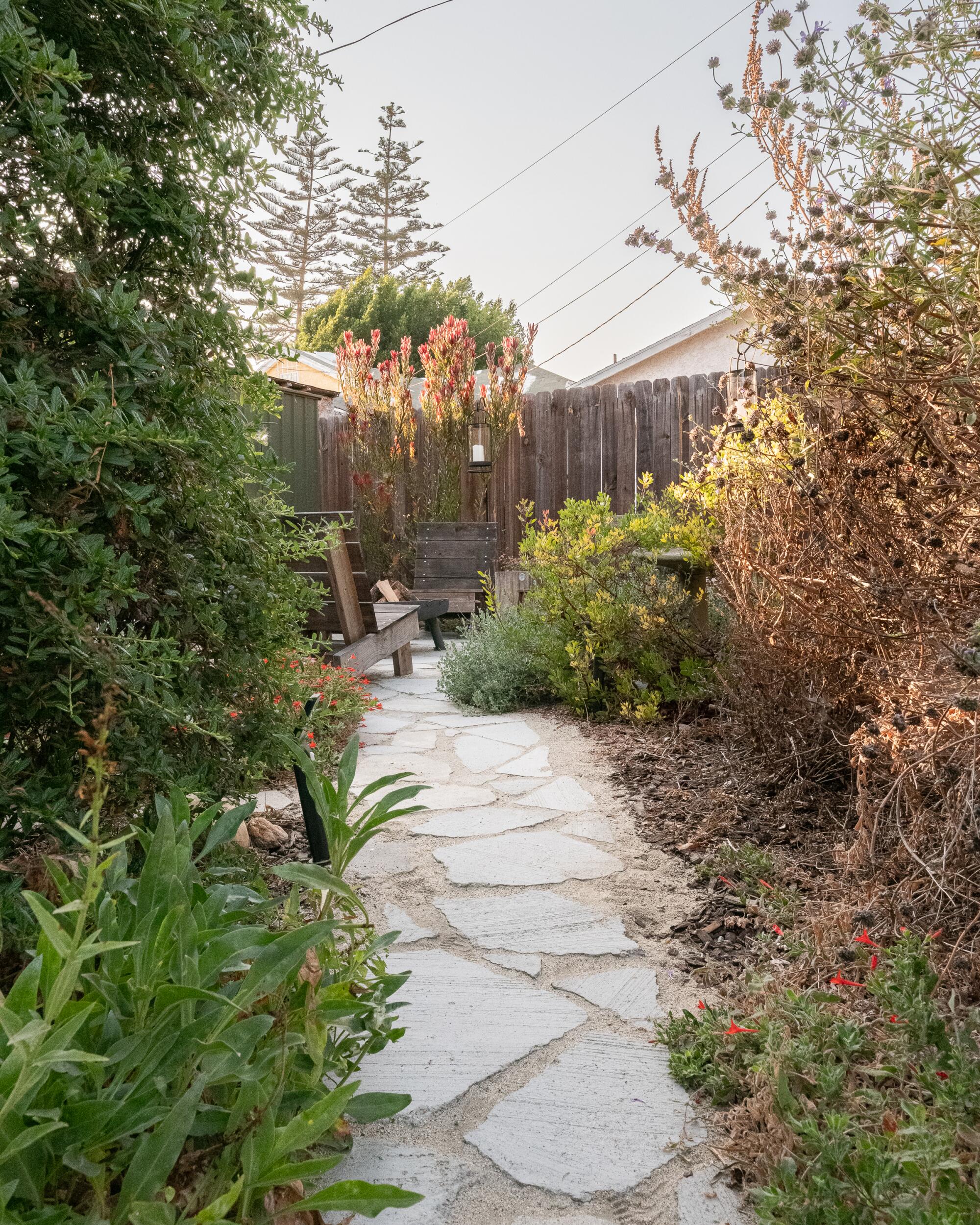 A concrete pathway leads to the backyard.