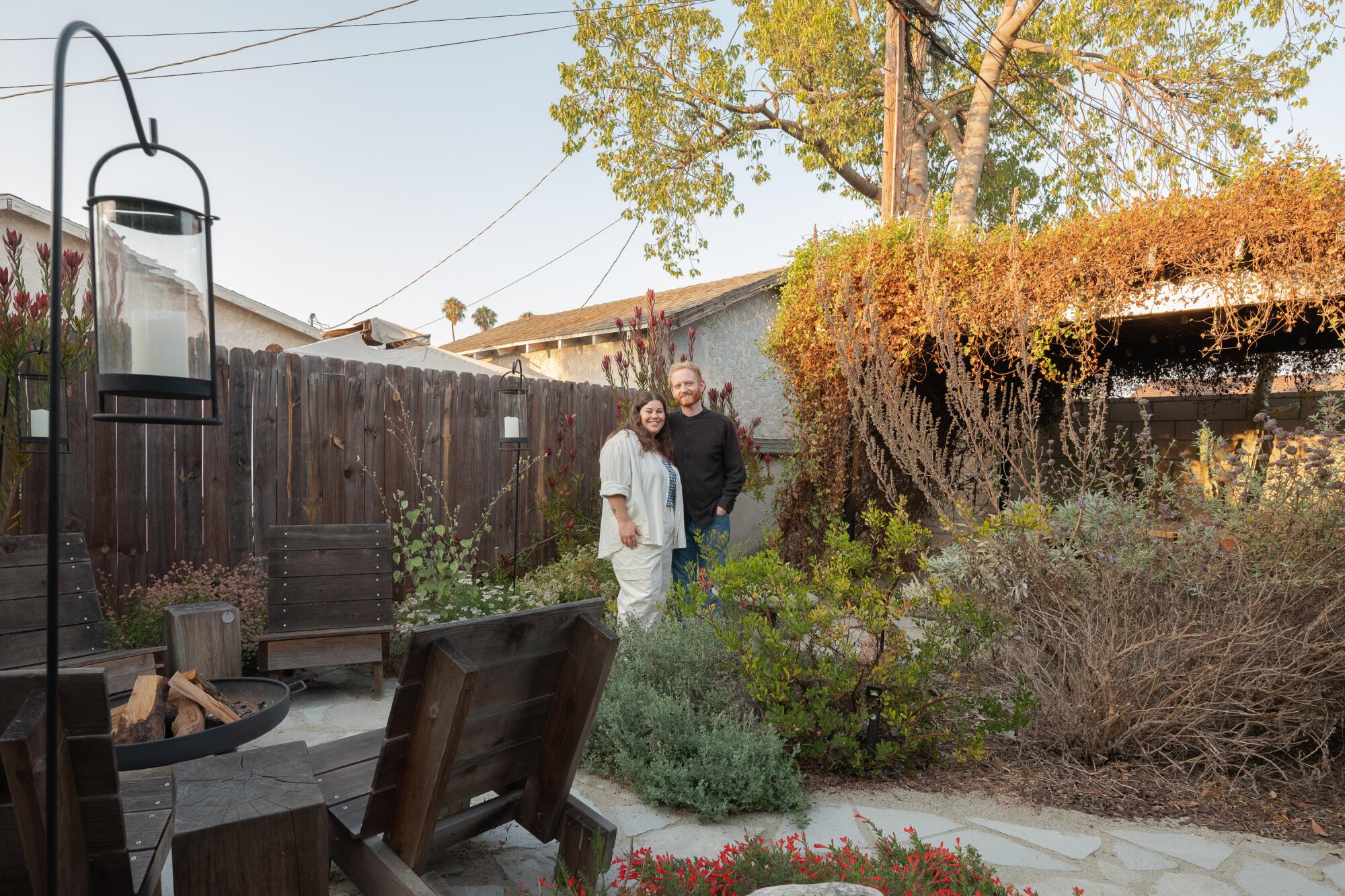Lexie Glass and her husband, architect Evan Hursley stand in their backyard 