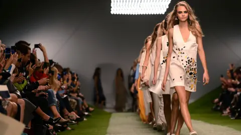 Getty Images Cara Delevingne walks the runway of the Unique show during London Fashion Week SS14 at TopShop Show Space on September 15, 2013 in London, England. 