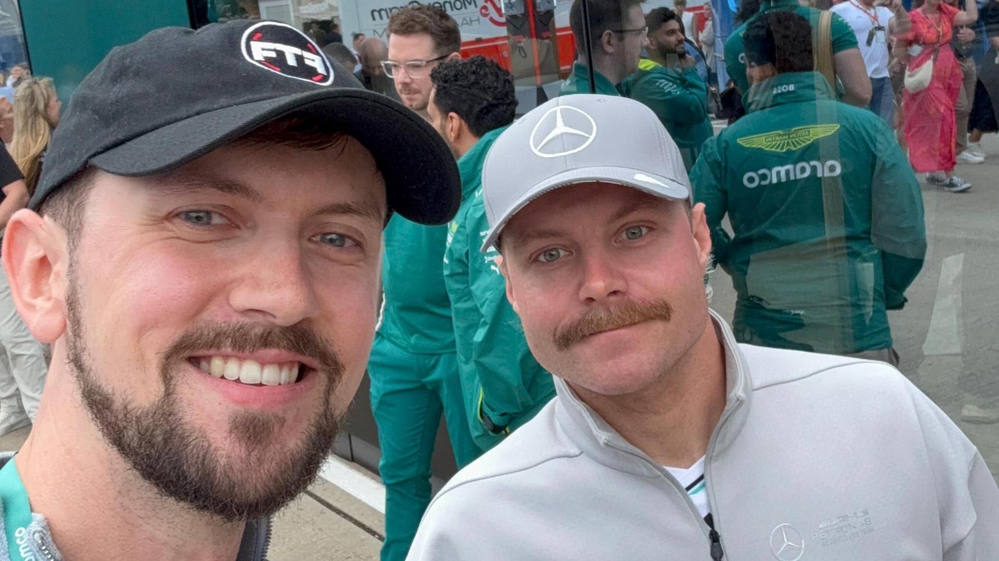 Brandon Burgess and Valtteri Bottas pose for a selfie