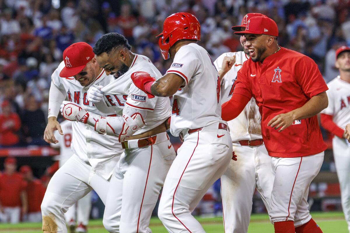 Teammates swarm Jo Adell after his walk-off hit