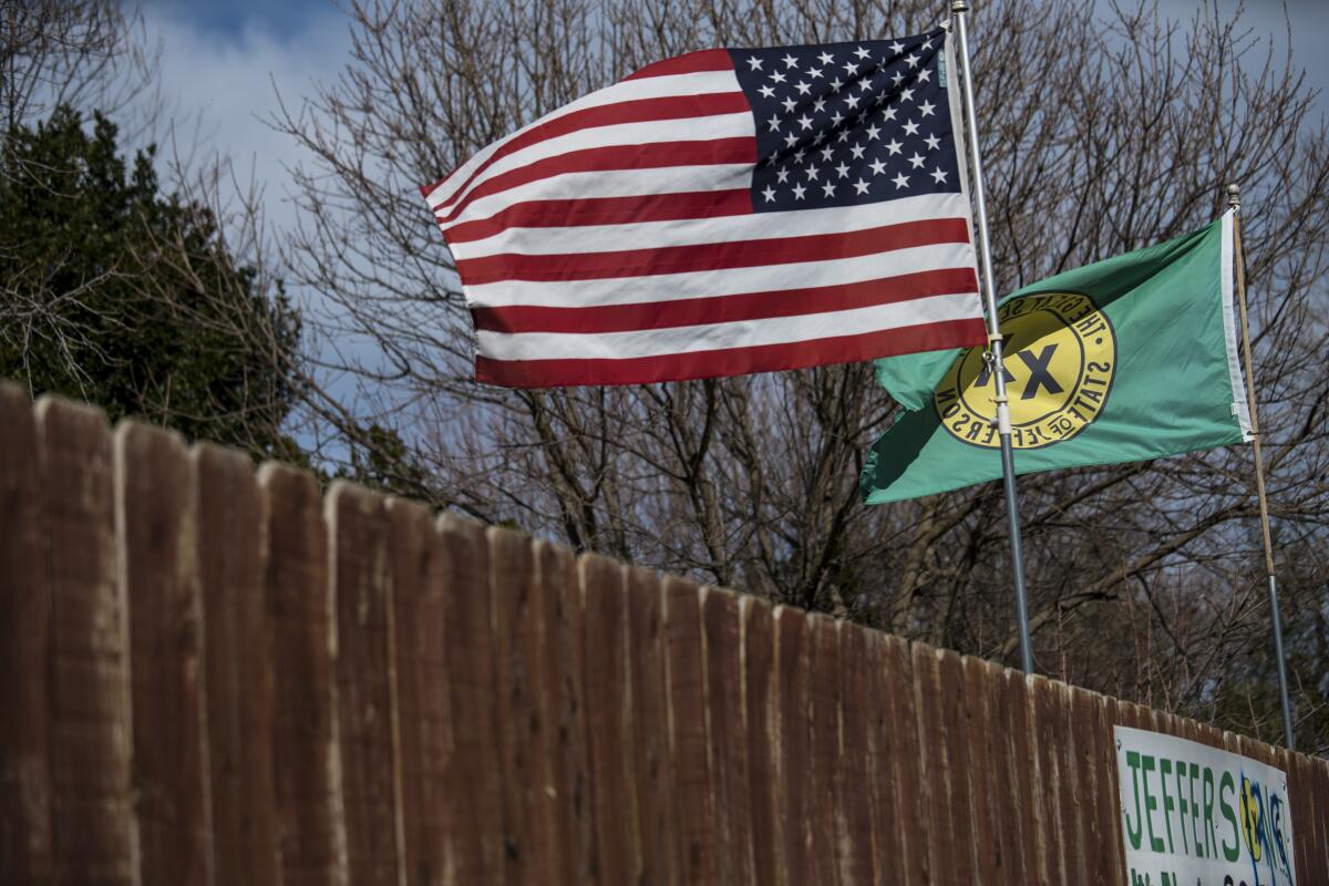 A Feb. 2018 photo shows the flags of the United States and the "State of Jefferson" in Anderson, Calif.