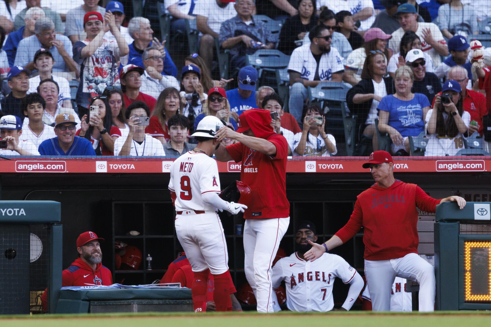 Angels shortstop Zach Neto celebrates with teammates after hitting a home run in the sixth inning Monday against the Dodgers.