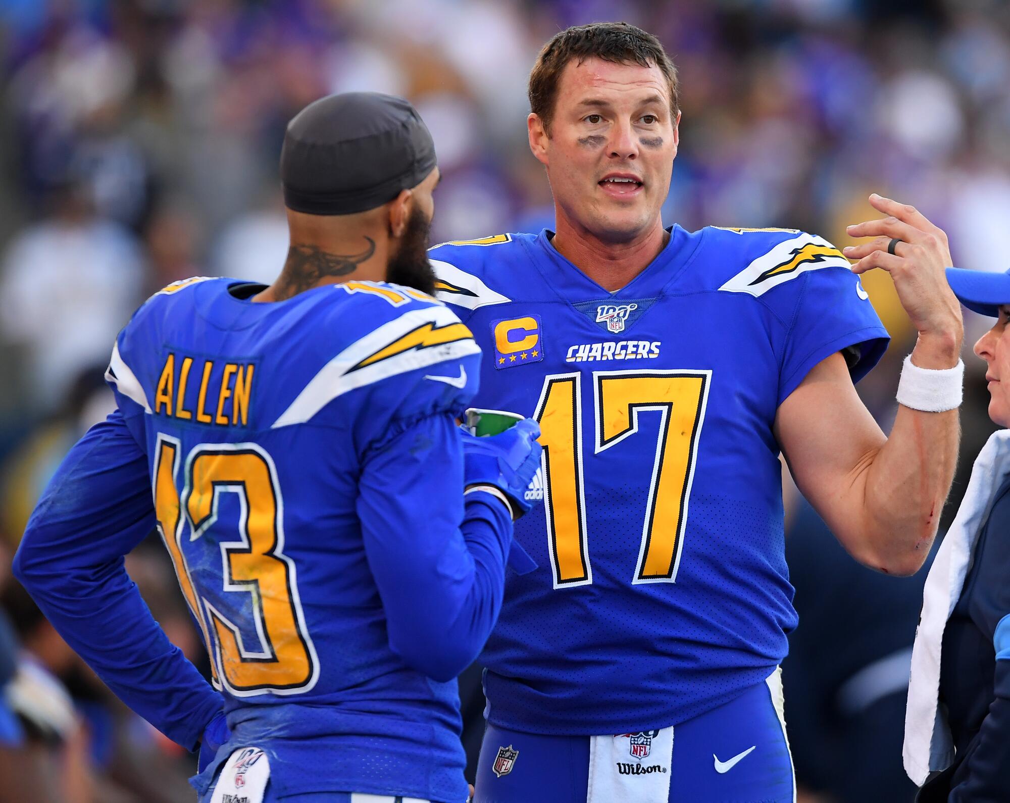 Chargers wide receiver Keenan Allen, left, speaks to quarterback Philip Rivers on the sideline.