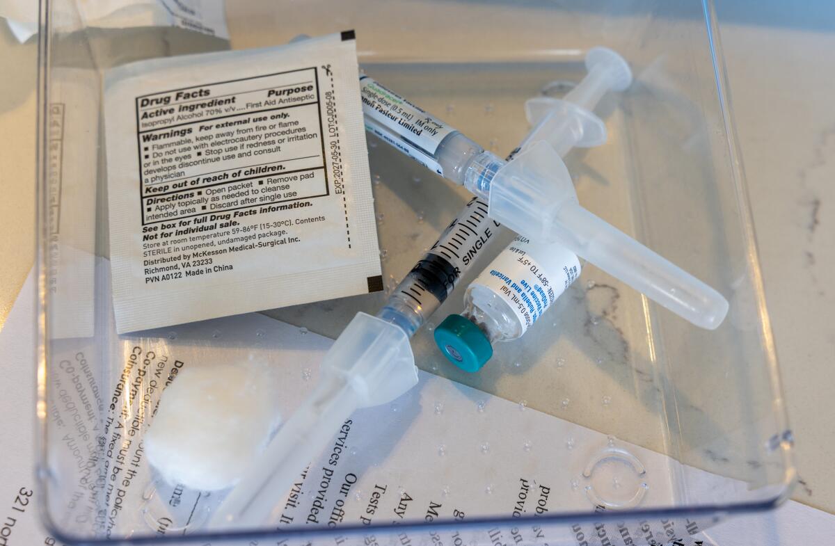 A vaccine sits in a tray ready to be administered.