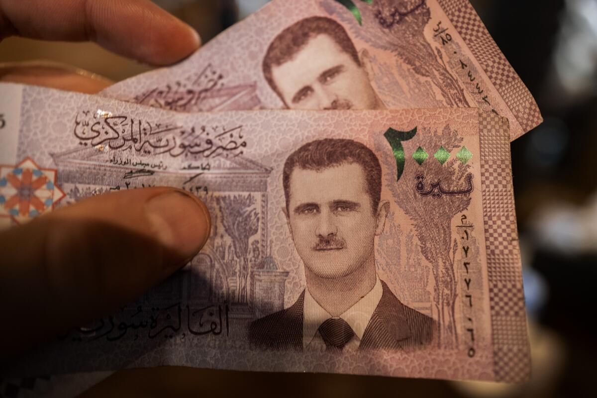 The face of ousted Syrian dictator President Bashar al Assad decorates the Syrian pounds
