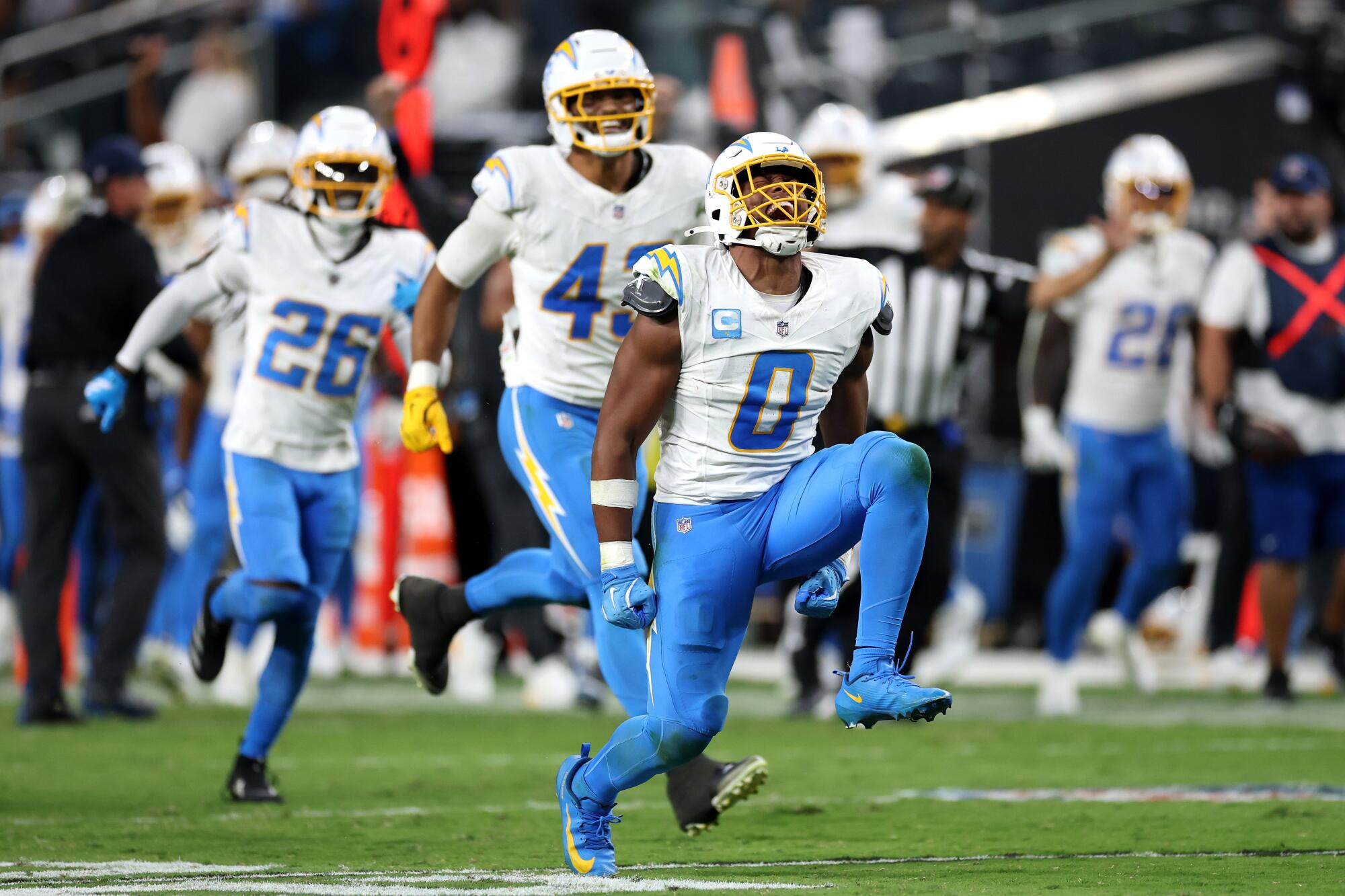 Chargers linebacker Daiyan Henley celebrates after sacking Raiders quarterback Geno Smith.