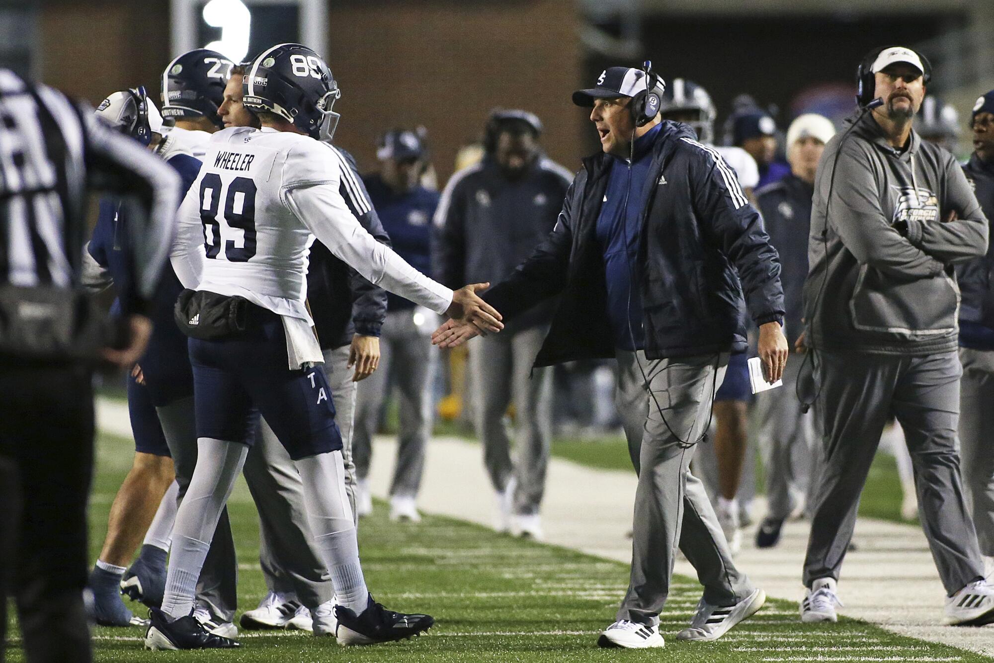 Georgia Southern coach Clay Helton and long snapper Jackson Wheeler celebrate during a game against Marshall.