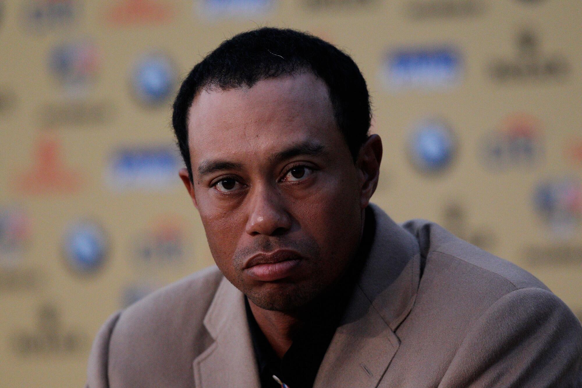 American Tiger Woods attends a tense news conference after Europe's victory over the U.S. at the 2010 Ryder Cup.