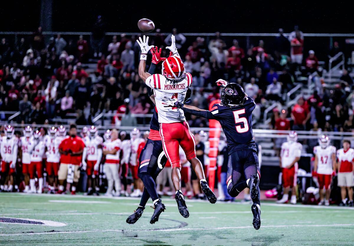 Kayden Dixon-Wyatt of Mater Dei leaps trying to catch pass, but Jaden Walk-Green came down interception.