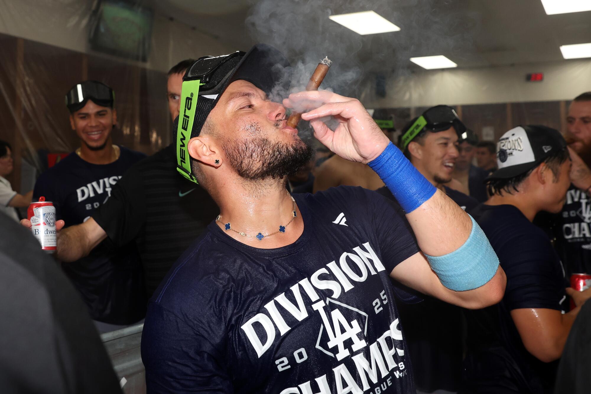 Dodgers infielder Miguel Rojas celebrates in the locker room after the team's win over Arizona to clinch the NL West title.