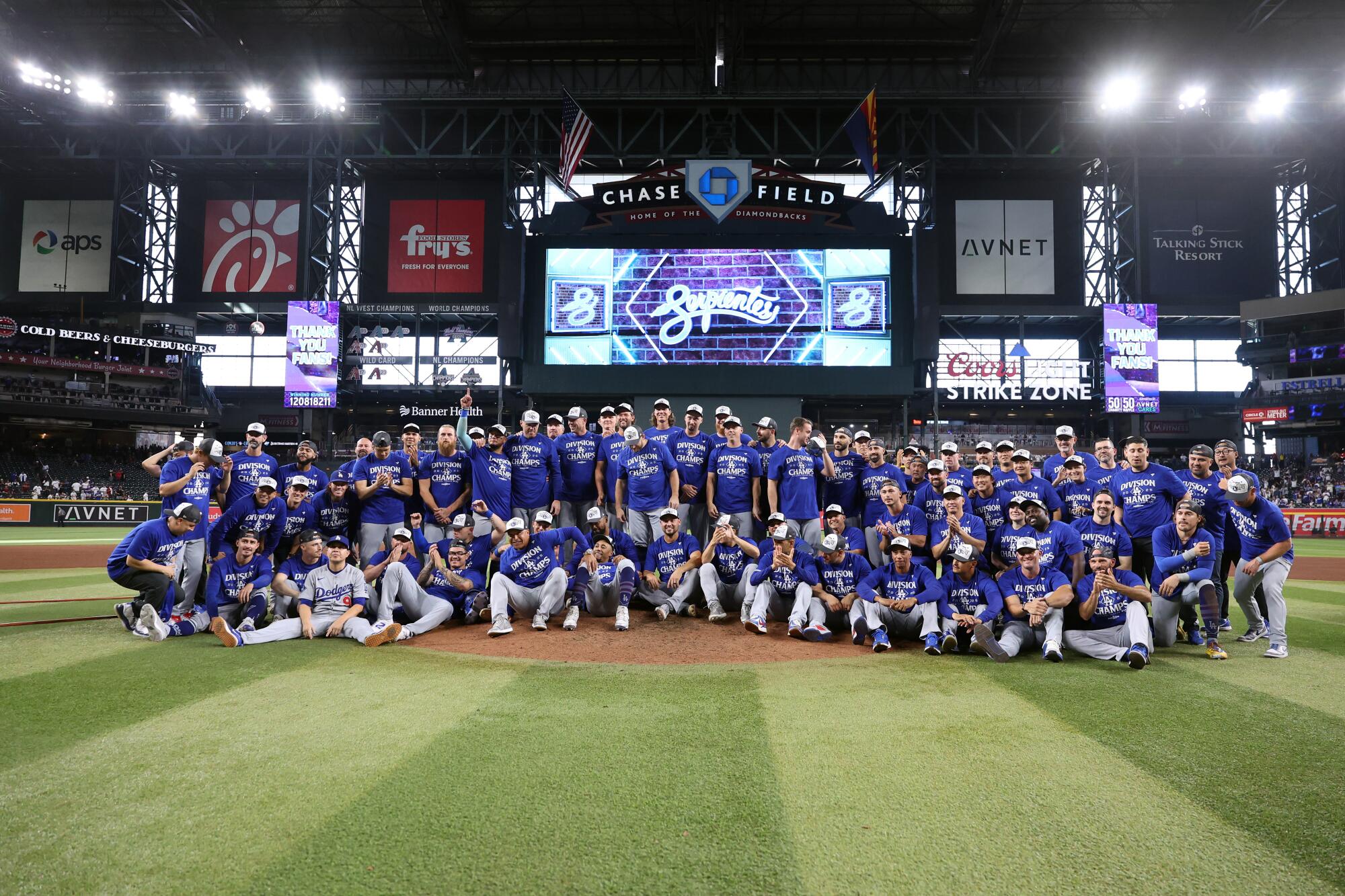 Dodgers players and coaches pose for a team photo at Chase Field after beating the Diamondbacks.