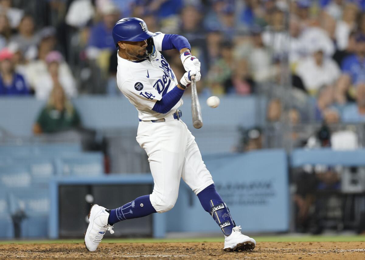 Dodgers shortstop Mookie Betts hits a home run in the bottom of the seventh inning against the Phillies.
