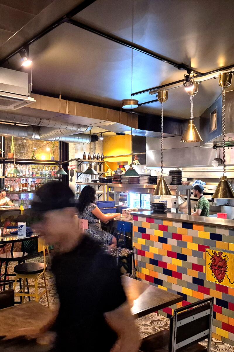 1. Interior view of dining room and kitchen at Mi Tocaya.
