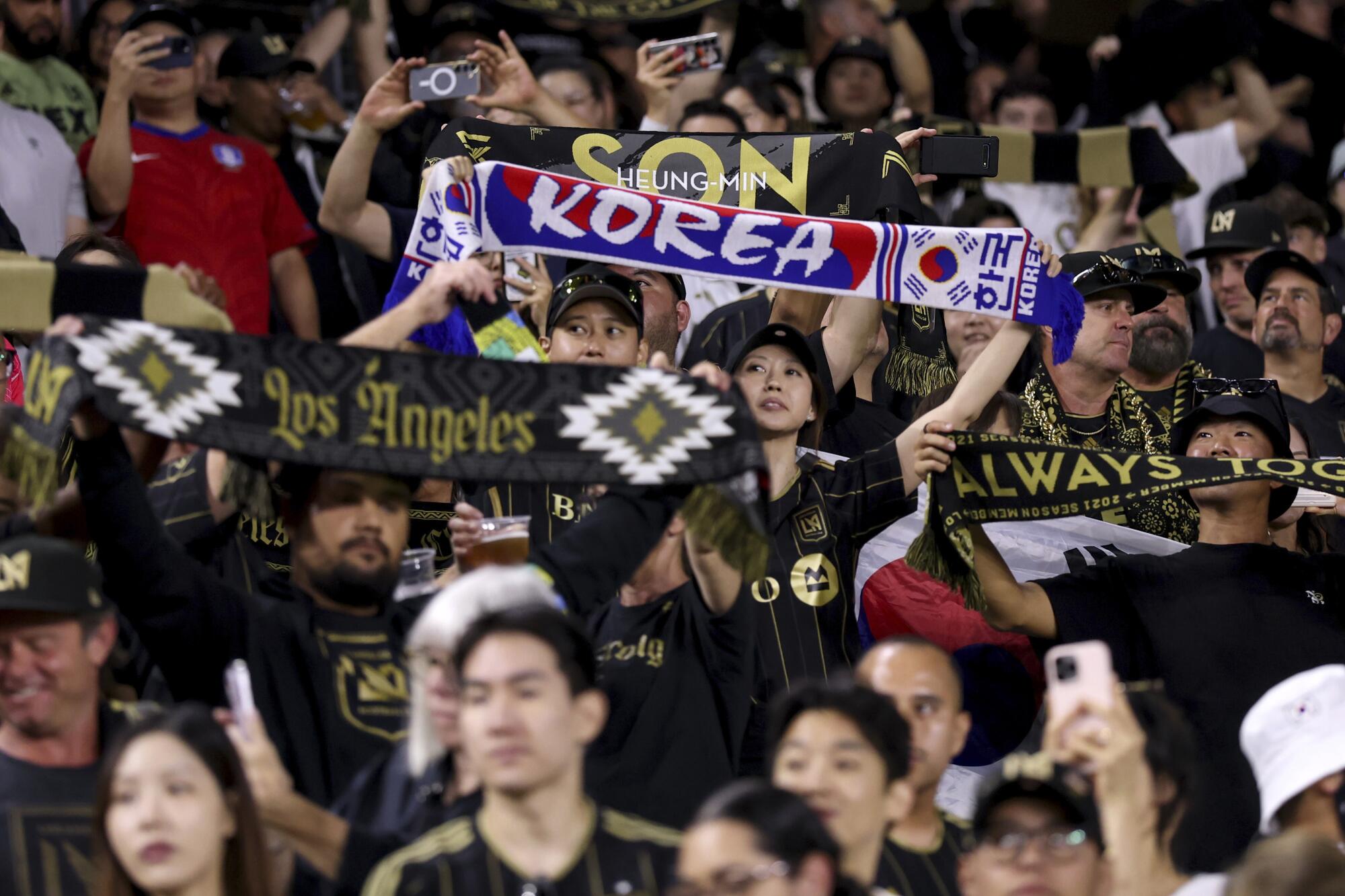 Fans wave signs honoring South Korea and Son Heung-min during LAFC's match against San Diego FC Sunday at BMO Stadium.