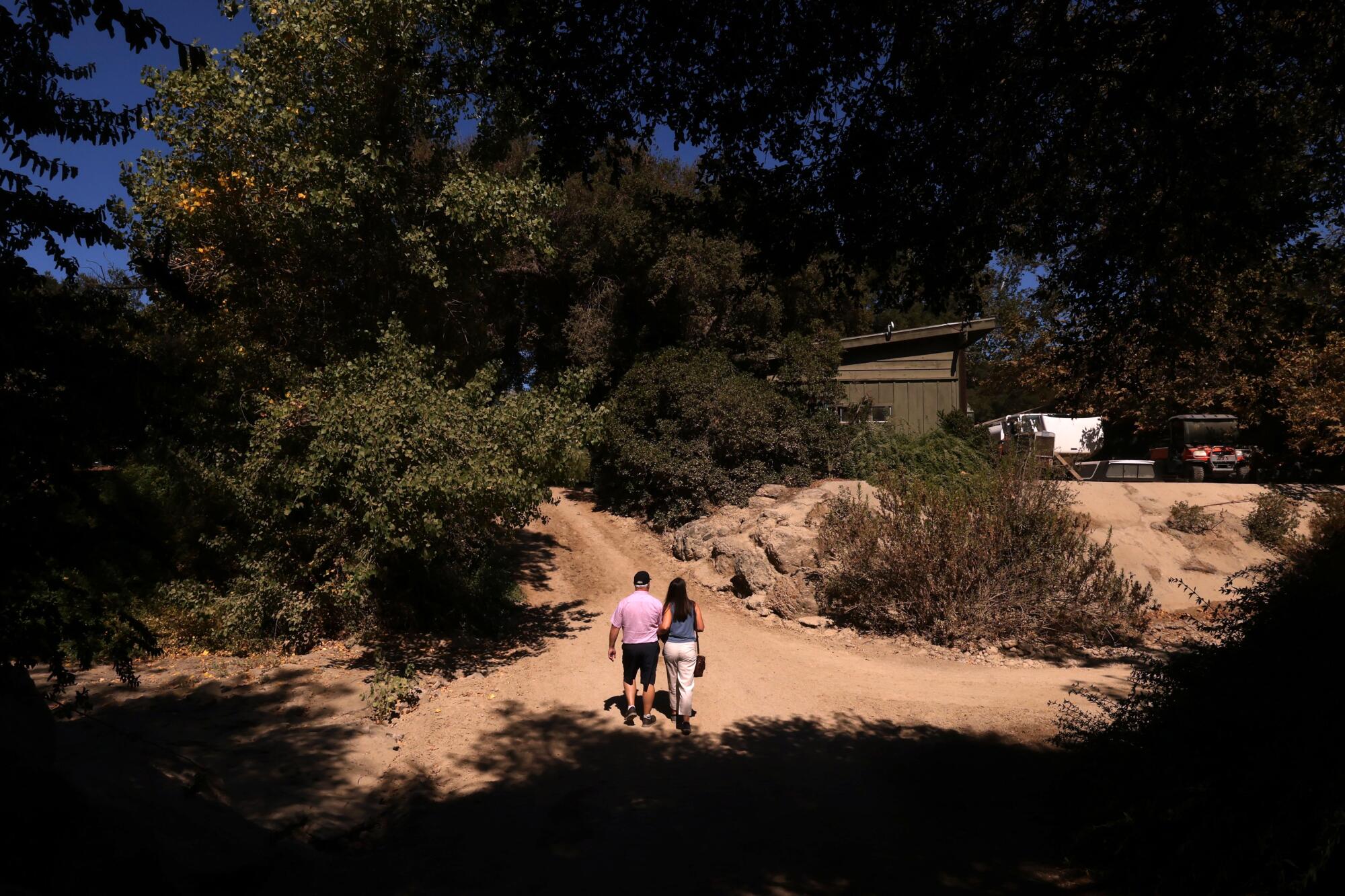 Marc and Julia Pierrat walk hand-in-hand at the Foxfield Riding School in Lake Sherwood.