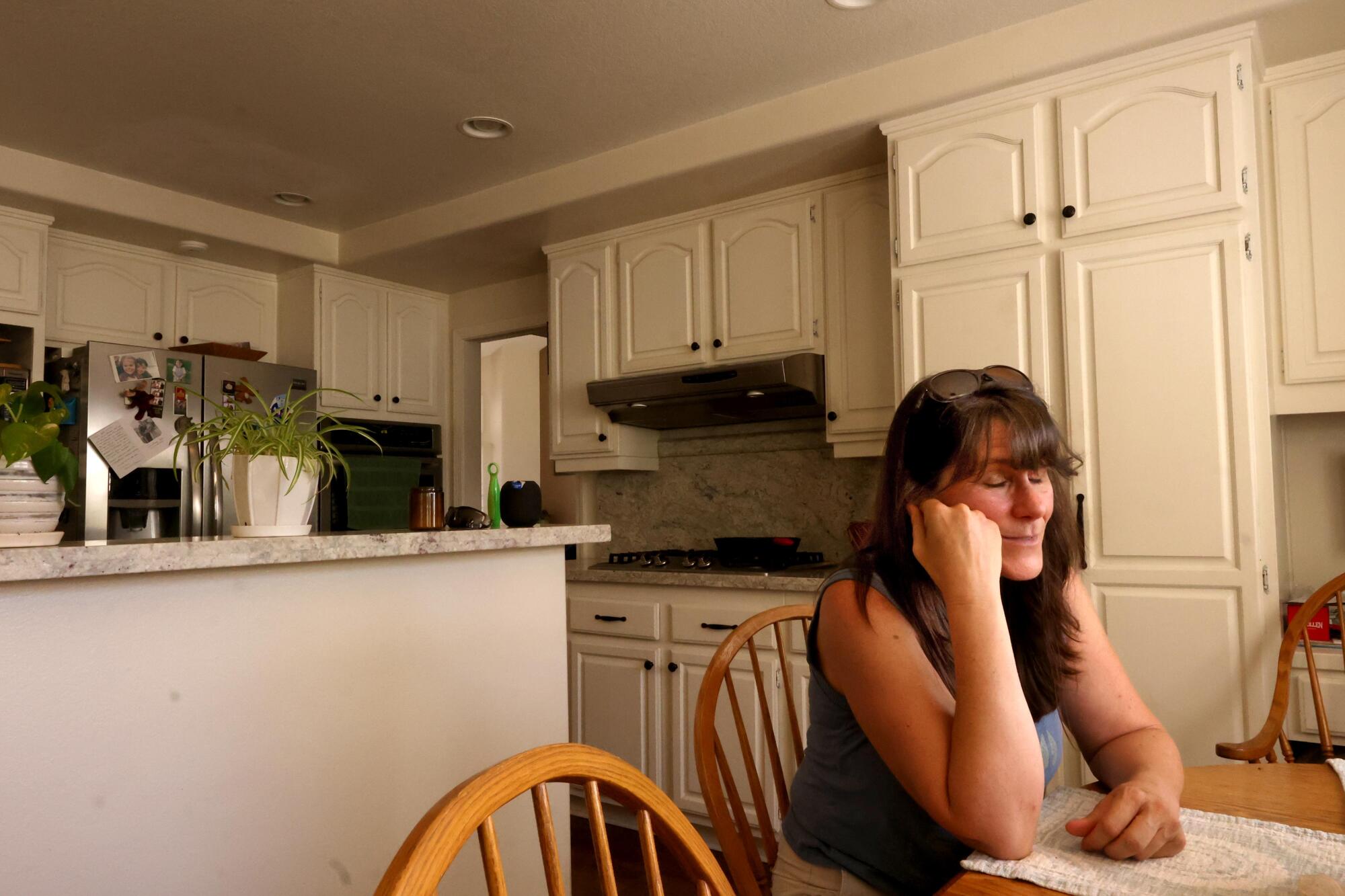Julia Pierrat spends a quiet moment in the kitchen of the family home in Westlake.