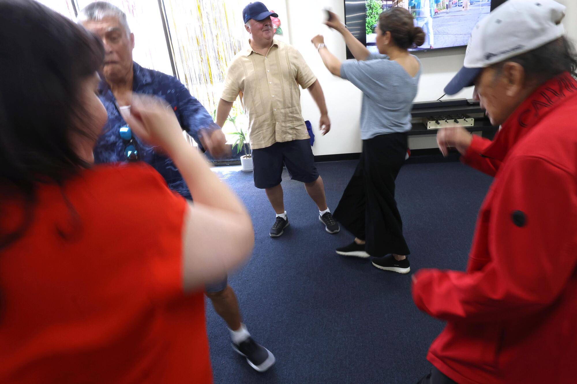 Marc dances with activity counselor Rhoda Nino at Infinity Adult Day Health Care Center in Westlake Village.