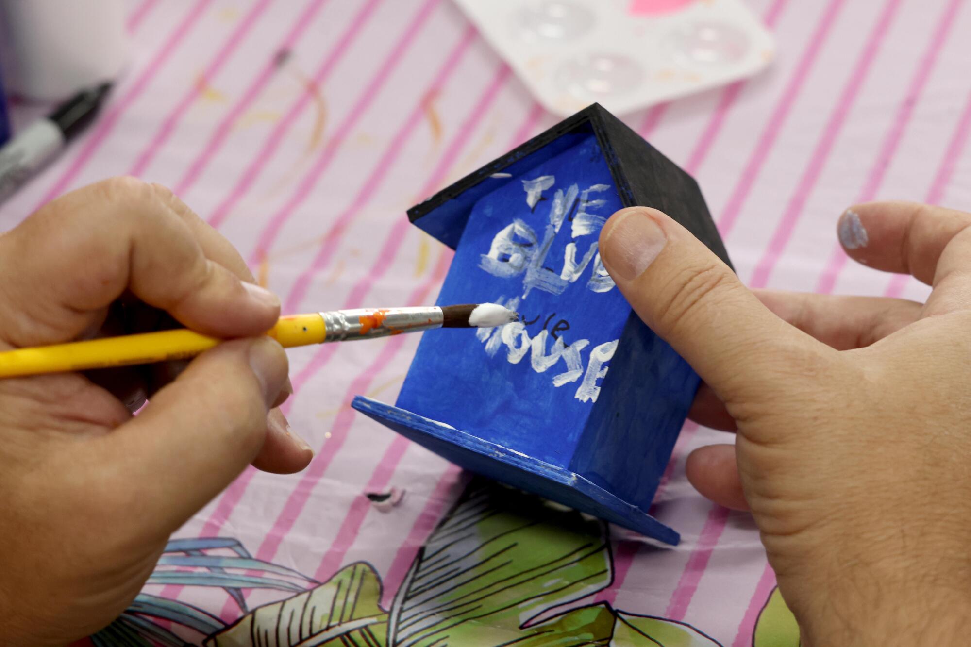 Marc Pierrat paints a bird house during an art class at Infinity Adult Day Health Care Center in Westlake Village.
