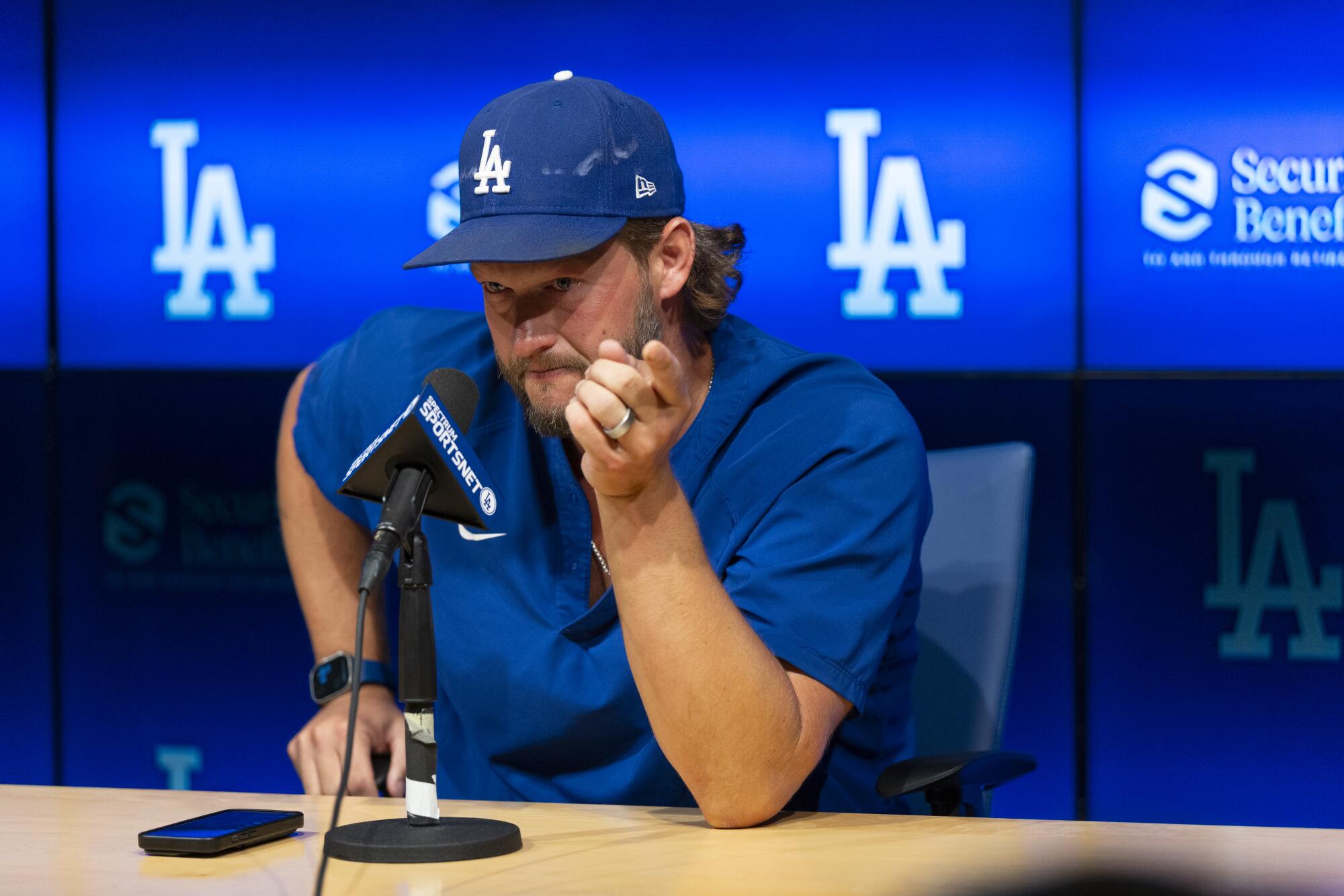 Dodgers pitcher Clayton Kershaw gets emotional as he points toward his teammates.
