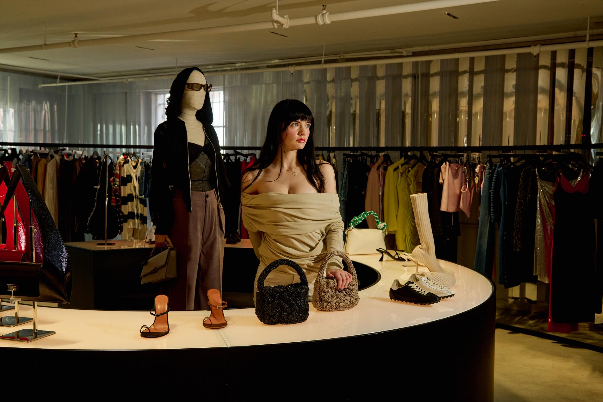Joanna Downing, sales associate at the H. Lorenzo women’s store, wears Entire Studios top, MM6 jeans .