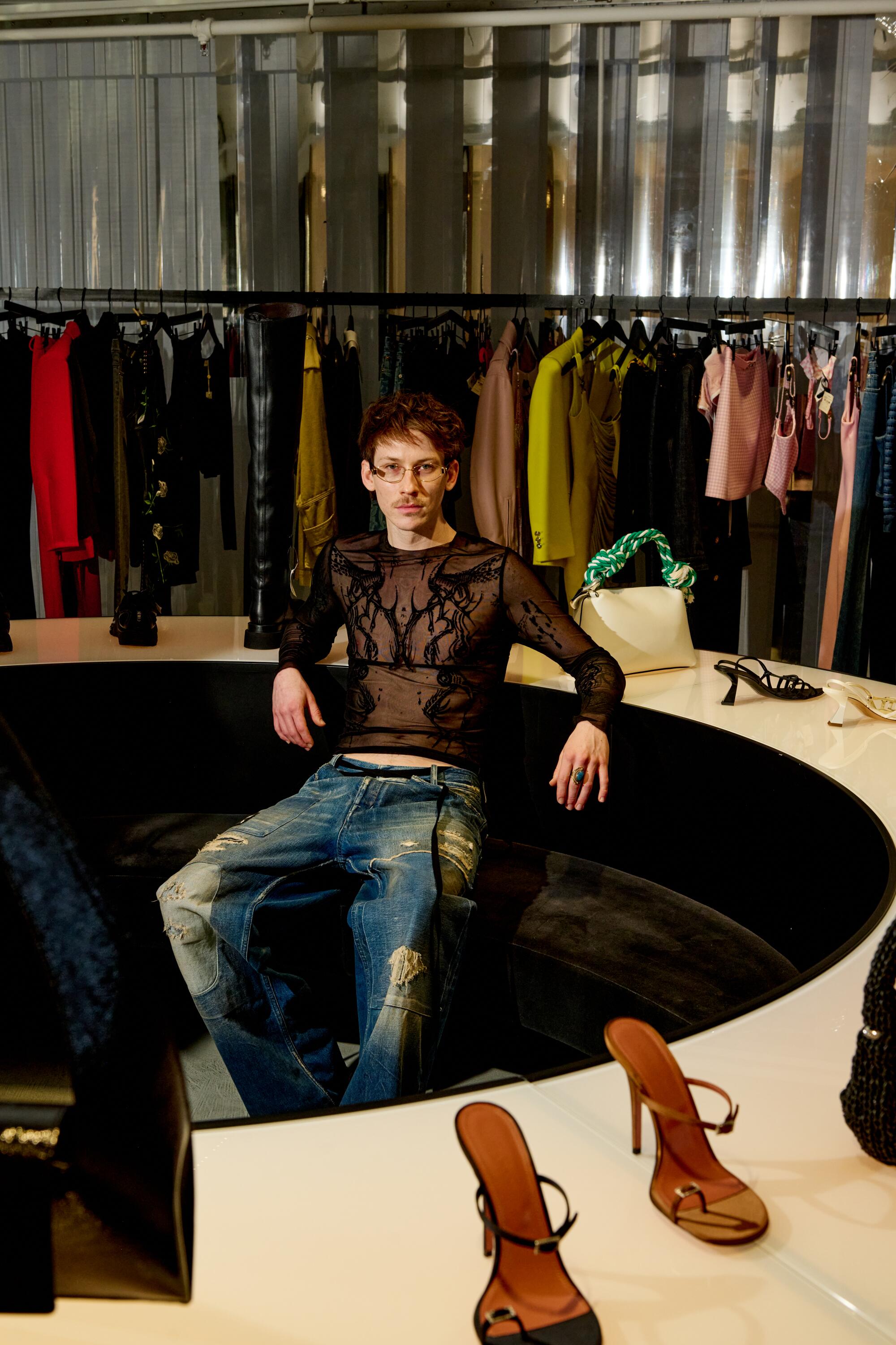 Michael Harris, asst. manager at the H. Lorenzo women’s store, wears Ann Demeulemeester jeans, ASOS shoes & Versace glasses.