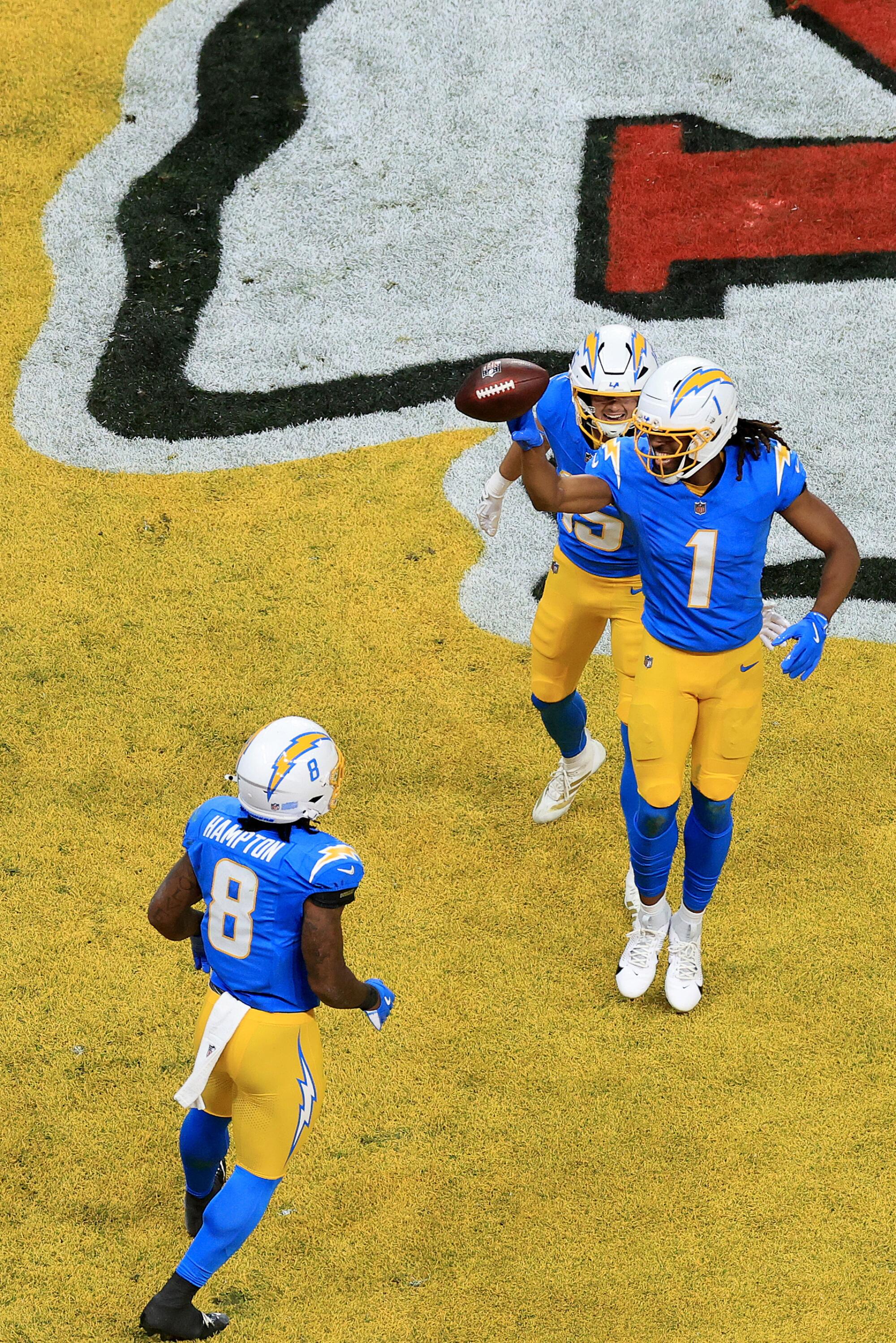 Chargers wide receiver Quentin Johnston (1) celebrates with Ladd McConkey (15) and Omarion Hampton.