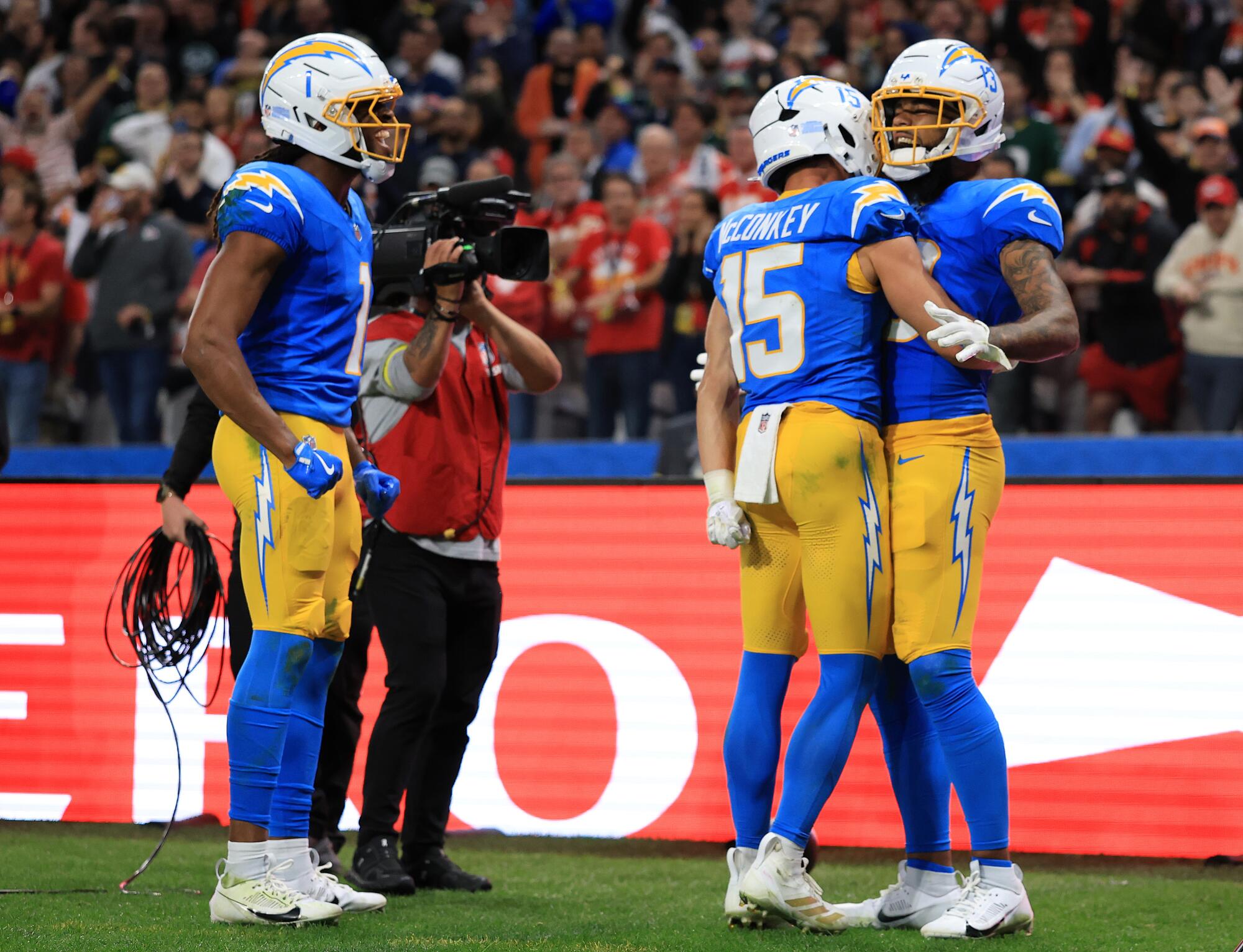 Chargers wide receiver Keenan Allen celebrates with Ladd McConkey and Quentin Johnston.