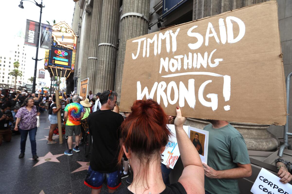 People protest in front of the Jimmy Kimmel Theater a day after ABC pulled the late-night host off air.