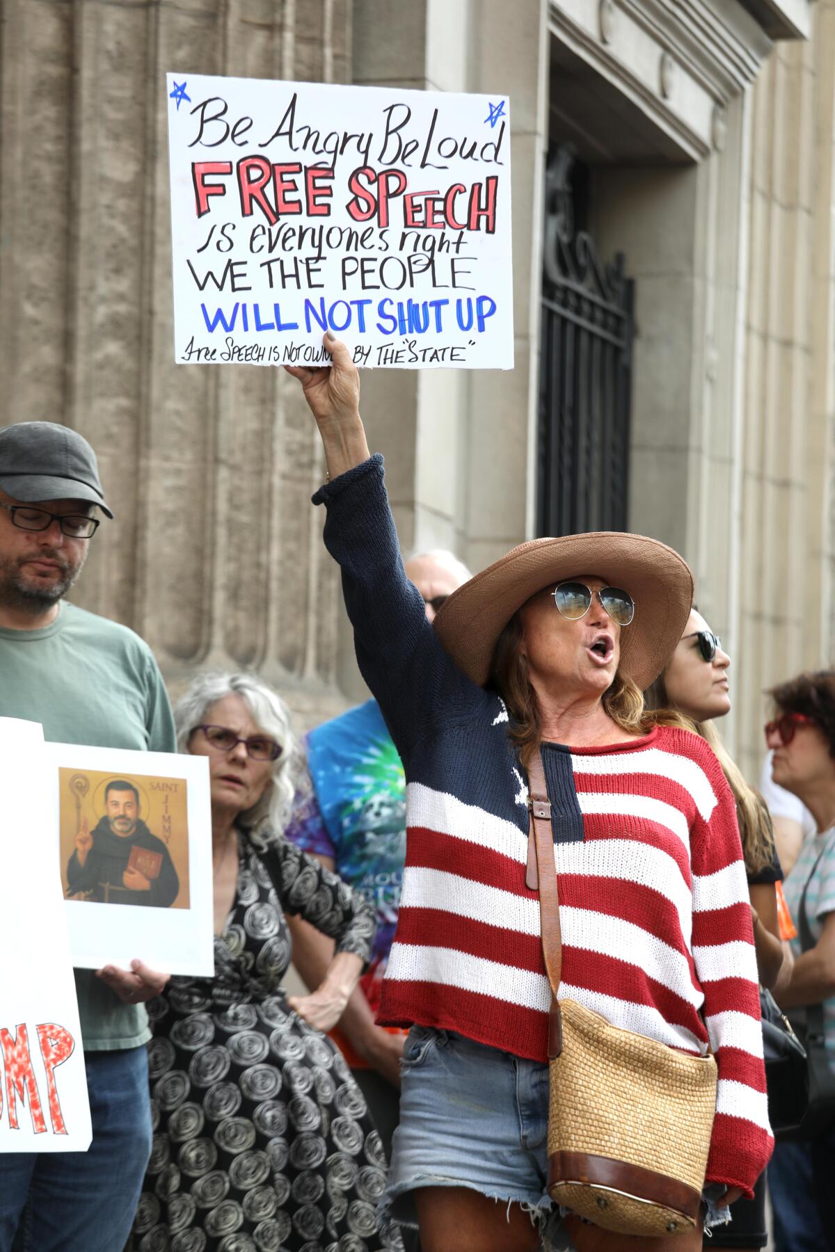 People protest in front of the Jimmy Kimmel Theater.