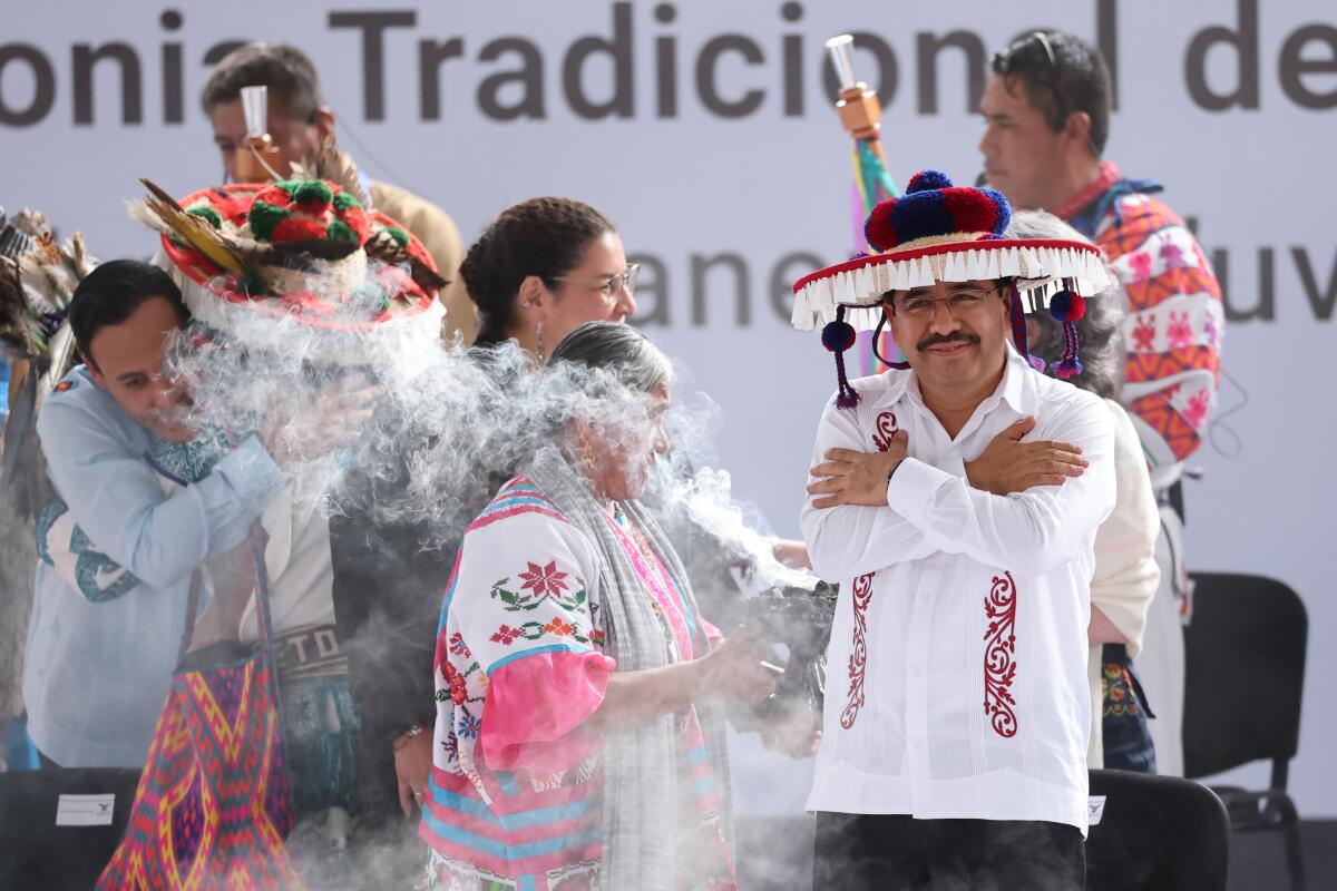 Supreme Court President Hugo Aguilar Ortiz receives a traditional purification ceremony